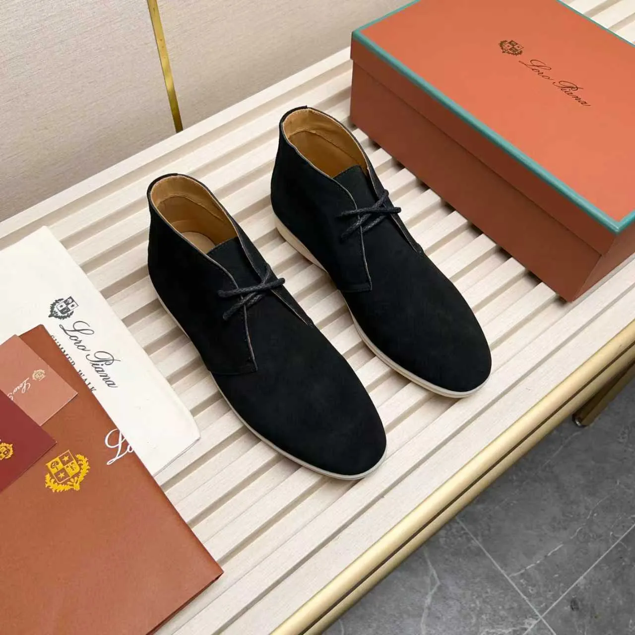 Men's Shoes 💰420 Loro Piana reimagines the desert boot—a modern, comfortable interpretation of a classic 1940s style. Crafted from suede calfskin, it exudes elegance. The tight texture of suede calfskin is not only durable but also looks casual and sophisticated. Add a timeless piece to your shoe collection, harmoniously blending comfort, style and Loro Piana's heritage of craftsmanship. Acetate satin detail on the inside White sole with LP lettering for added traction Space for a personalized signature on the heel Tonal suede trim Upper: 100% cow split suede Sole: 100% Rubber lining: Cow leather
